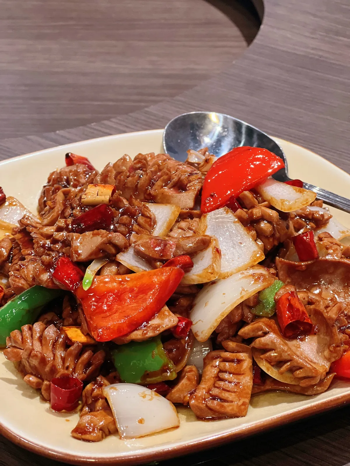 Plate of stir-fried meat with peppers and onions