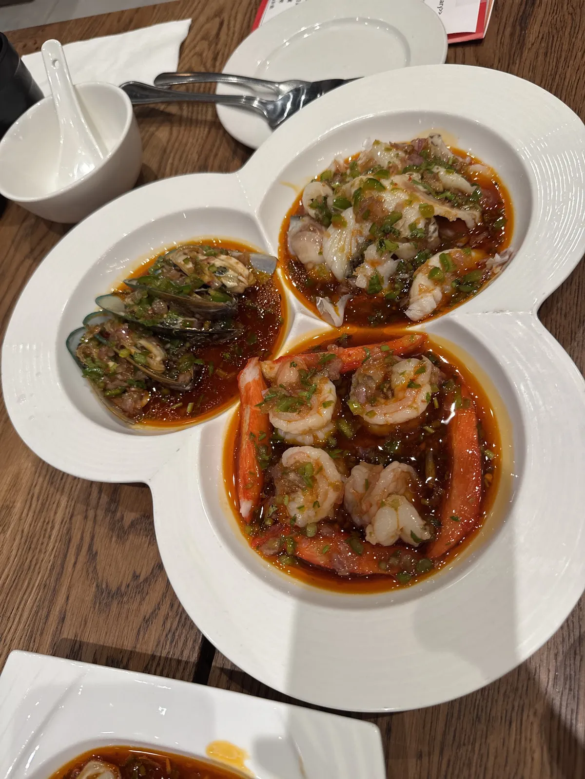 Seafood platter with mussels, shrimp, and squid in sauce